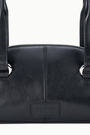 Mini shoulder bag close-up with stitched front and embossed logo patch