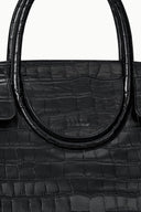 Black croc-embossed handbag with stitched oval handle opening and front panel