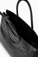 Black croc-embossed tote with open top, stitched side panel, and carrying handle