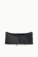 Black clutch bag with smooth finish, tie closure, and short shoulder strap