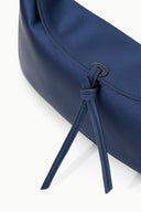 Dark sapphire clutch close-up of bow tie and top stitching detail