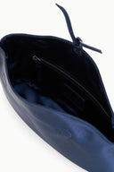 Dark sapphire clutch interior with dark lining and zip pocket, open top