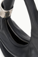 Black leather cuff bag interior with zip pocket and gold zipper teeth detail
