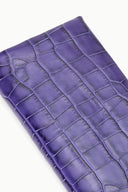 Purple croc-embossed leather clutch close-up with scaled texture pattern