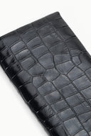Croc-embossed leather clutch exterior close-up with glossy grid pattern