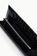 Croc-embossed leather clutch interior with stitched lining and metal zipper