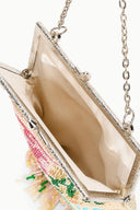 Beaded frame bag open view showing beige lining and silver chain hardware