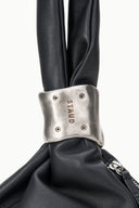 Black leather cuff bag with silver snap cuff and zipper opening
