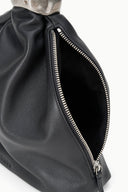 Black leather cuff bag with silver zipper and dark lined opening