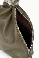 Cuff bag with side zipper and dark brown interior lining