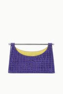 Crocodile-pattern purple clutch with silver bar handle and yellow-lined interior