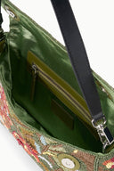 Beaded bag interior with green lining, inner zip pocket, and black shoulder strap.