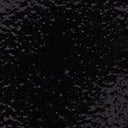 Close-up of glossy black glaze ceramic texture with speckled sheen