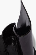 Black glazed wavy holder close-up, curved teardrop opening with glossy finish