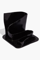 Black glazed stationary holder with two compartments and glossy wavy walls