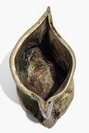 Ceramic vase top view, open interior with dark glaze and mottled speckled finish
