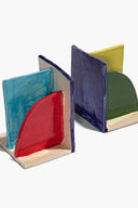 Ceramic bookends with teal, red, dark blue, and green glazed book supports.