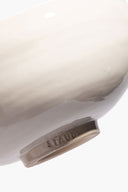Large ceramic candle in white ceramic vessel with embossed SERRE on rim