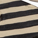 Close-up of striped glaze pattern on tray holder rim, black and cream