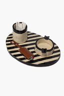 Striped glaze tray holder set with two cup holders and utensils on striped round tray