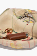 Ceramic catch-all dish with keys and brown leather strap; STAUD printed on interior