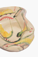 Ceramic catch-all dish with cream base and multi-color abstract glaze pattern