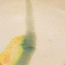 Glazed ceramic catch-all with cream surface and yellow-green abstract streaks