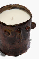 Top view of brown ceramic candle holder with visible wick and inner white wax