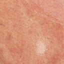 Pink glazed ceramic texture close-up with speckled finish