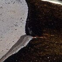 Ceramic ikebana holder corner detail with metallic dark glaze and light speckling