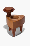 Wood trinket box with circular opening, hinged lid, and three pointed legs.
