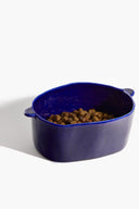 HENRY ceramic large dog bowl in glossy blue, filled with kibble, side handles