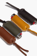 Leather lighter cover bundle with stitched trim, metal clasp, and leather tassel