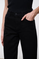Black high-rise jeans waistband detail with button closure and belt loops