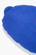 Blue plush floor pillow close-up, embroidered 4 outline and curved seam