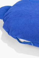 Blue plush floor pillow with visible zipper opening on edge