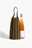 Beaded wine bottle bag with vertical multicolor stripes holding a glass bottle