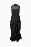 Black sleeveless high-neck dress with sheer bodice and draped knot front, feathered hem