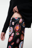 Silk pants waistband detail with black base and colorful circular paisley print
