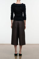 Dark brown leather culottes from back, mid-calf wide leg with patch pockets