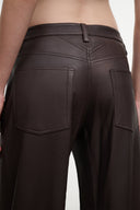 Dark brown leather culotte detailing: belt loops, stitched seams, patch pockets