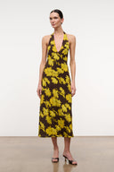 Front view floral halter midi dress with pink-trim V neckline and yellow daisies on black.