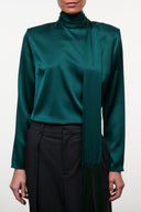 Emerald green satin-like top with high neck, long sleeves, and subtle seam details
