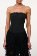 Black strapless corset dress with textured bodice and layered tulle ruffle skirt