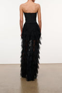 Black strapless corset dress, back view, with tiered tulle ruffle skirt
