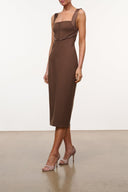 Brown sleeveless midi dress with draped bust, fitted waist, and back seam