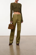Hale sweater dark green cable knit, cropped hem, long sleeves, worn with pants