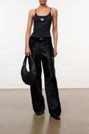 Black camisole tank top with spaghetti straps and small embroidered graphic at chest