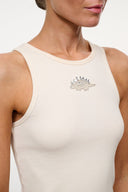 Ivory ribbed sleeveless tank with small embellished dino graphic at center chest.