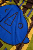 Cashmere blanket close-up of blue owl face within striped knit